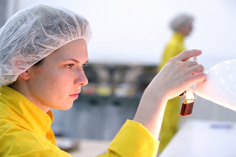 scientist examining vial in the lab